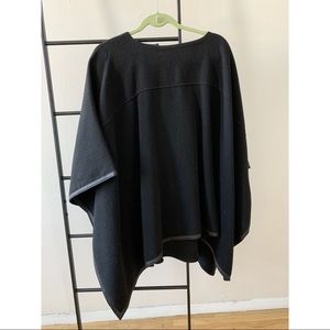 Gorgeous mid-weight wool poncho with lambskin leather trim.